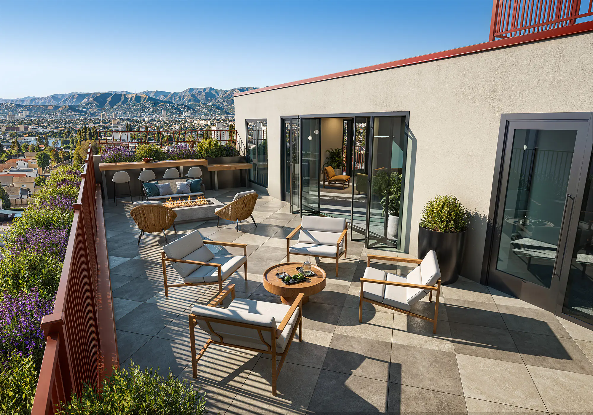 The Clark on 54th — elevated sixth-floor patio with fire pit, lounge seating, and landscaped planters